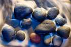 Lava beach rocks worn by centuries of sea water cover the black sand beaches of Bali Art Print
